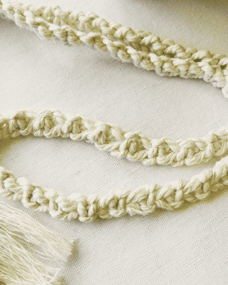 Close-up of handmade macramé strap – twisted cotton cord for phone bag or mini purse