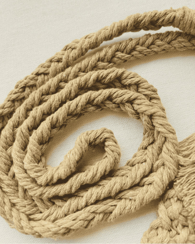 Close-up of the light brown cotton macramé strap showing intricate braided design and soft fibre texture.