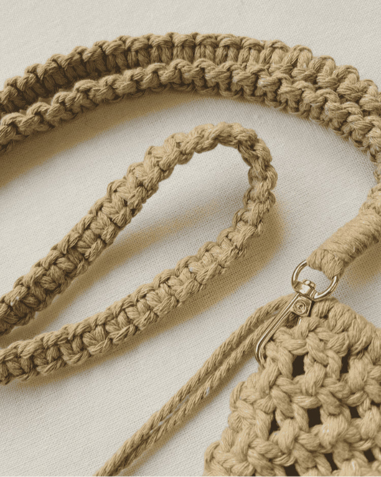 Braided cotton strap and gold clasp detail of macramé phone bag in light brown cord